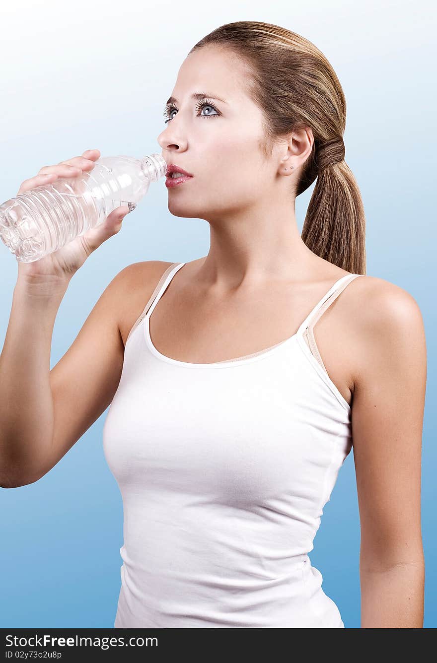 Young woman having a short break while exercising. Young woman having a short break while exercising