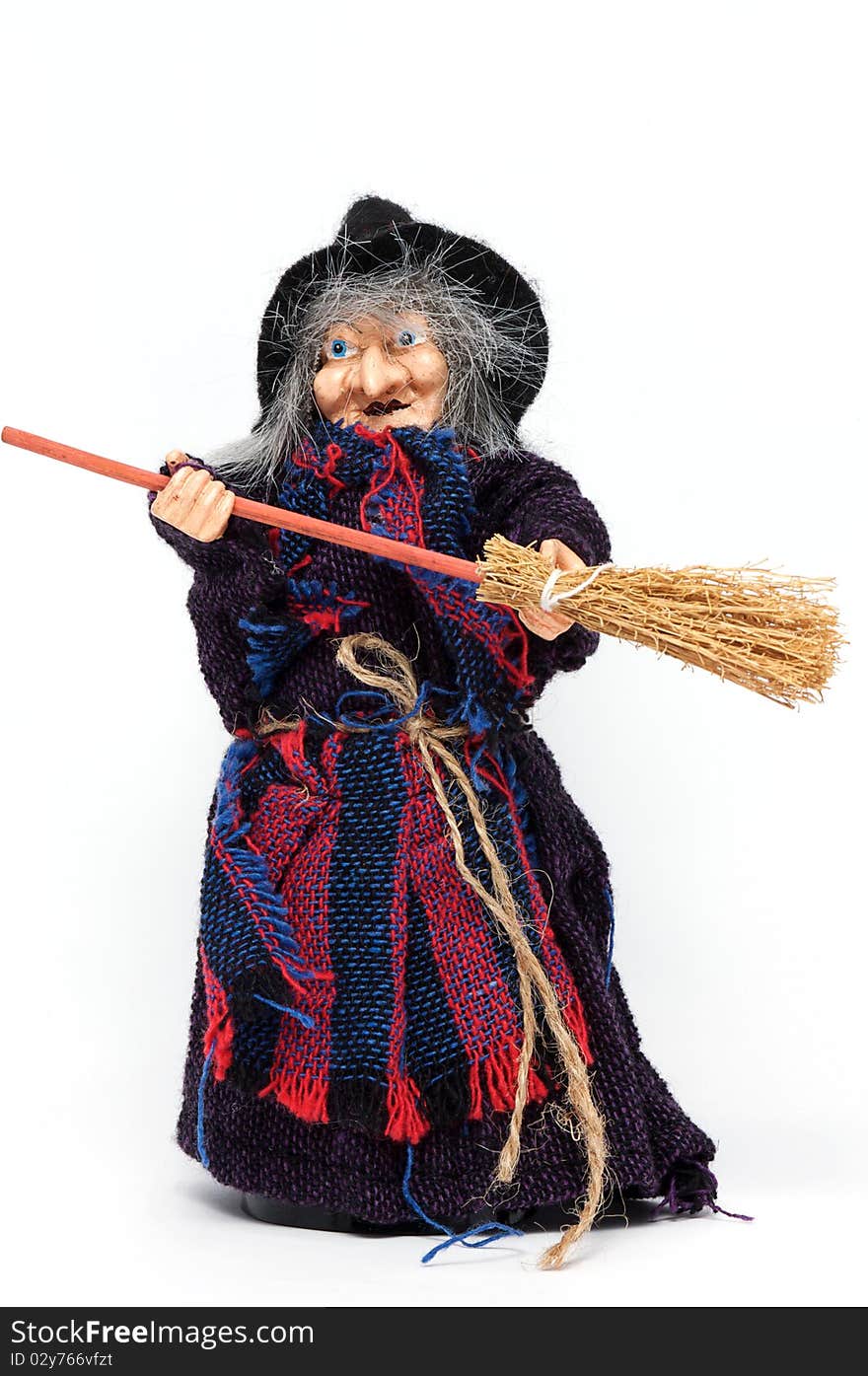 Old Halloween witch with broomstick and hat isolated on white background