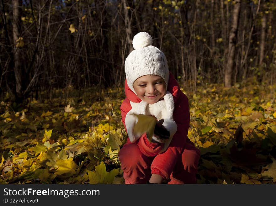 Little girl in autumn park