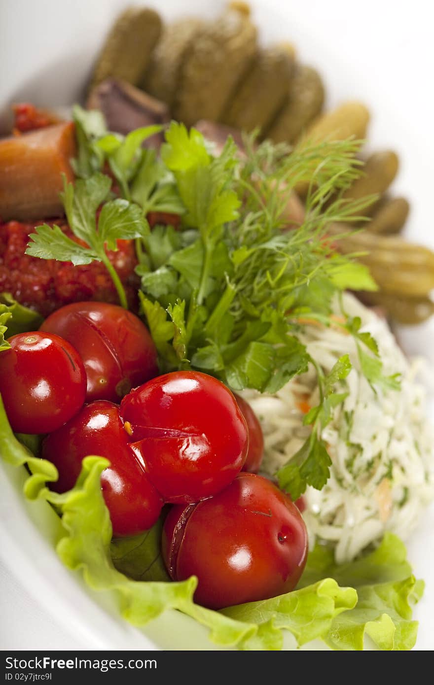 Marinated vegetables at the plate isolated on a white background