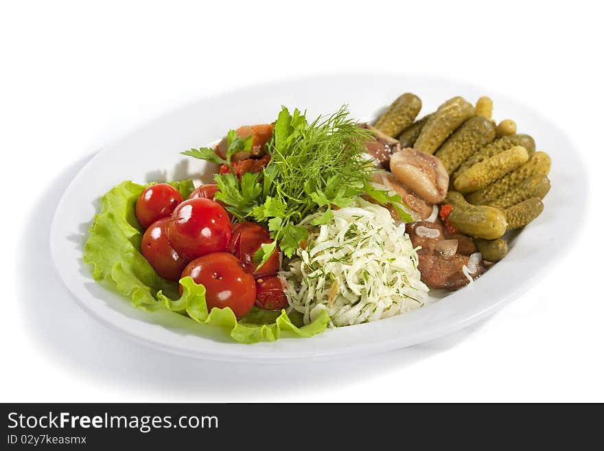 Marinated vegetables and mushrooms at the plate isolated on a white background