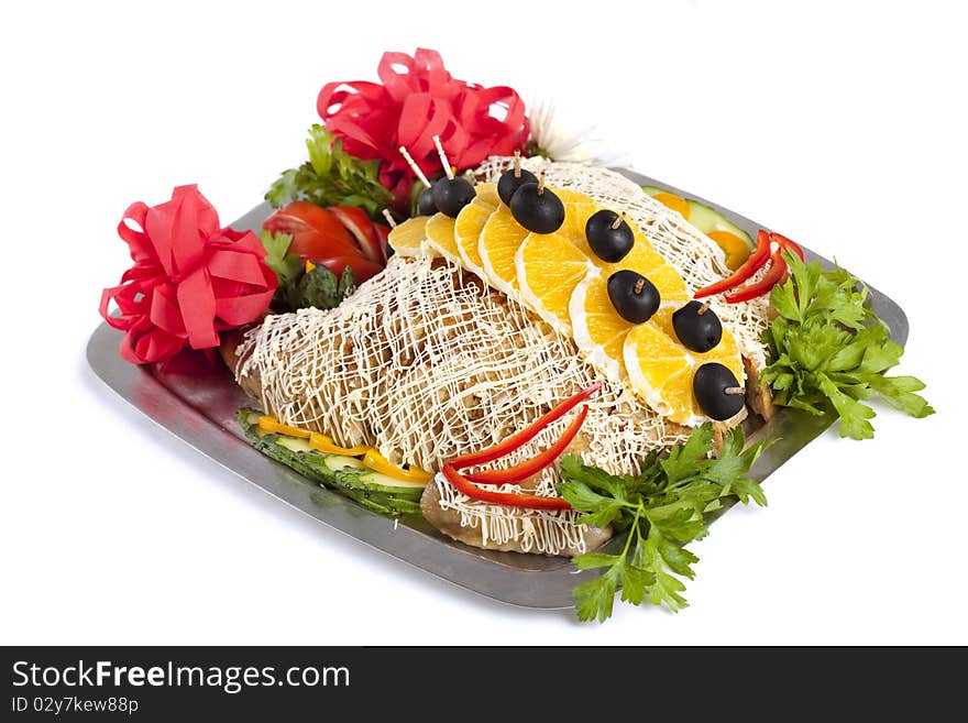 Baked stuffed chicken decorated with slice oranges and olives on skewers over white bacground. Baked stuffed chicken decorated with slice oranges and olives on skewers over white bacground