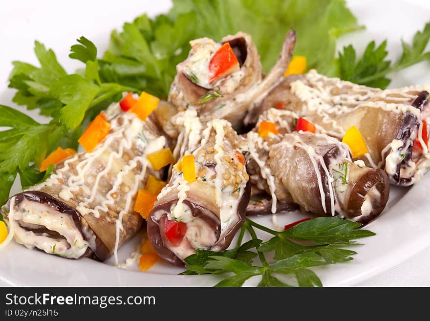 Baked Eggplant rolls stuffed Tomato and Dressed with Parsley. Over white background