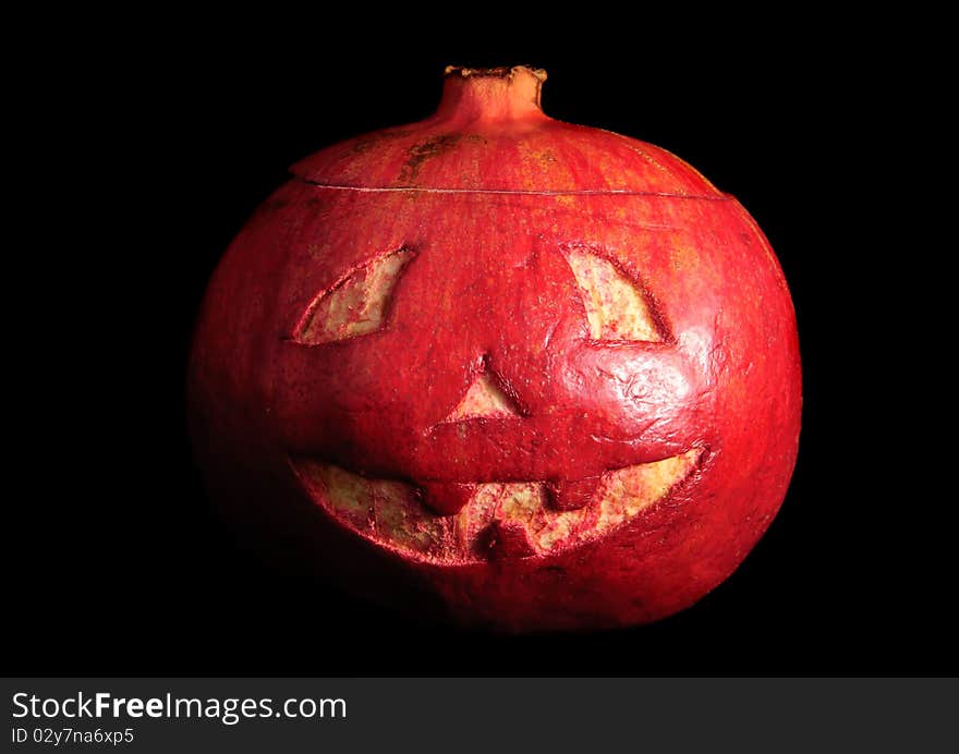 Halloween face cut out on fruit. Isolated on black. Halloween face cut out on fruit. Isolated on black