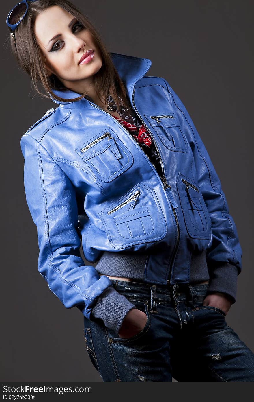 young woman with blue sunglasses, jeans and leather jacket