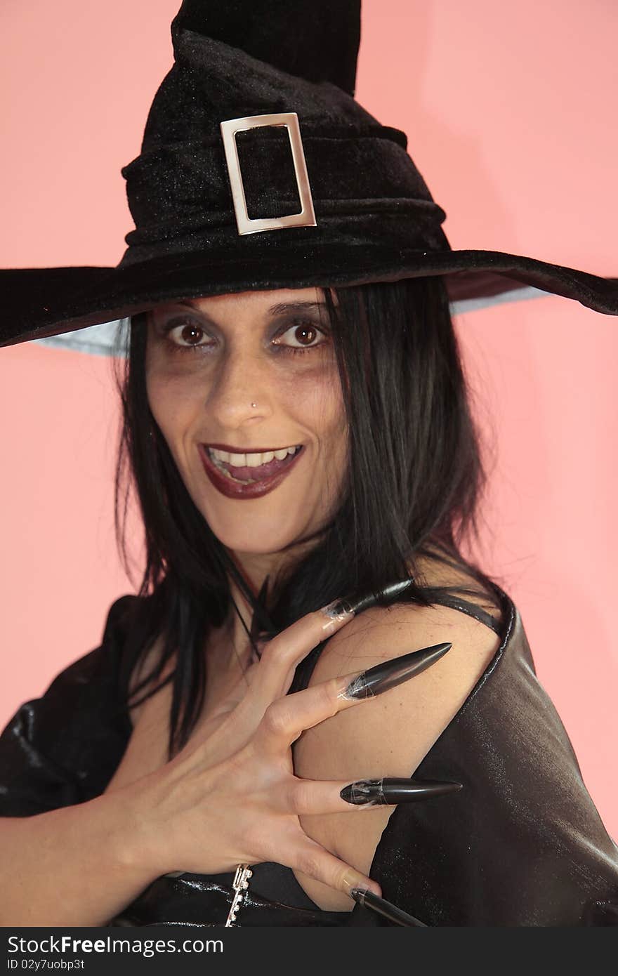 A beautiful witch halloween dark clothes and makeup. A beautiful witch halloween dark clothes and makeup