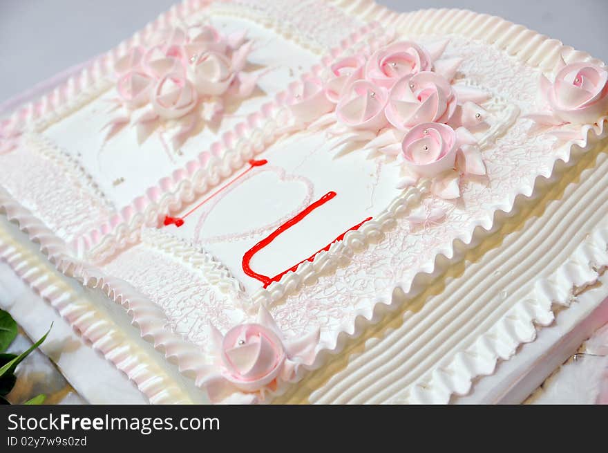 A pink wedding cake with book type