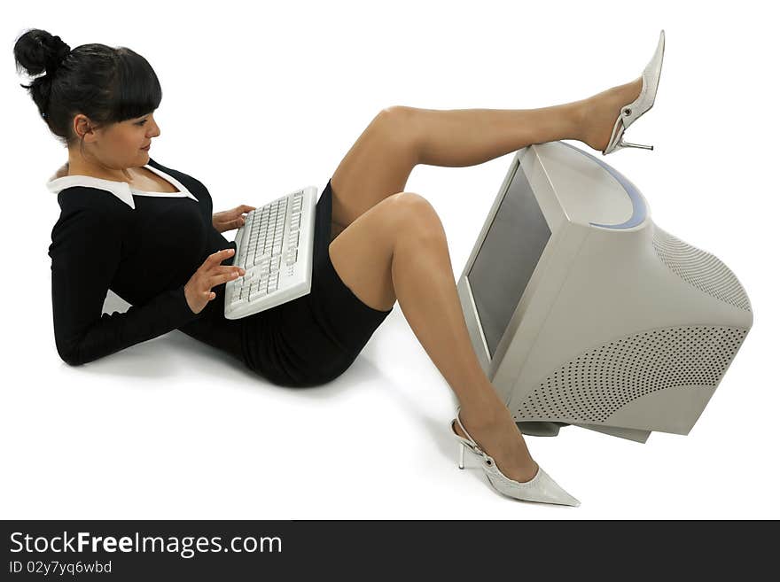 Smiling business woman with a keyboard looking at the screen  isolated over a white background