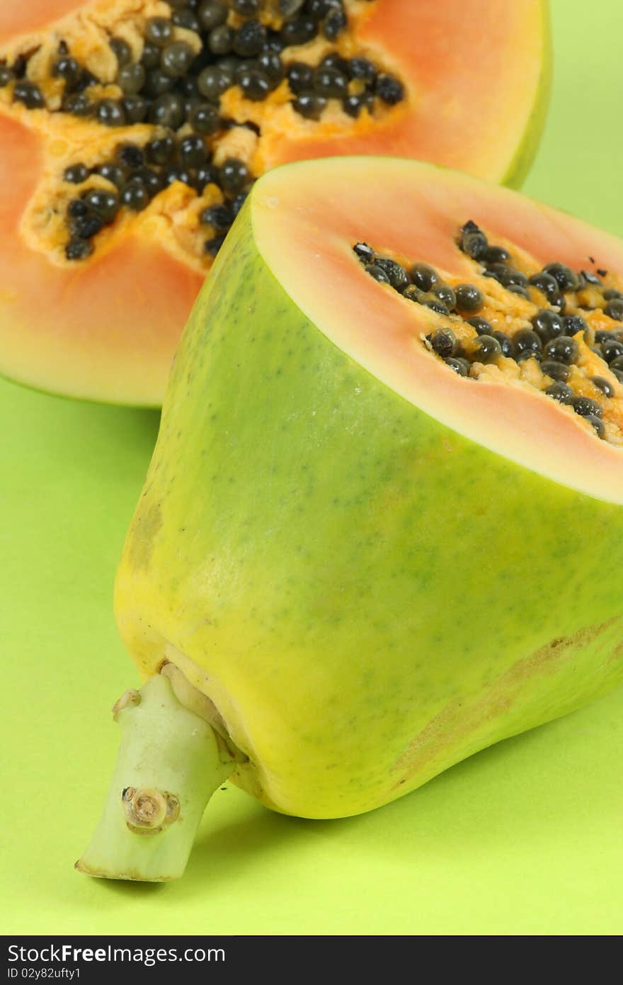 Papaya fruit cut in half isolated on a white background. Papaya fruit cut in half isolated on a white background.