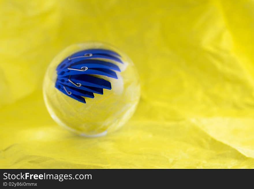 An optical illusion, four pegs seem to be in a glass ball. An optical illusion, four pegs seem to be in a glass ball