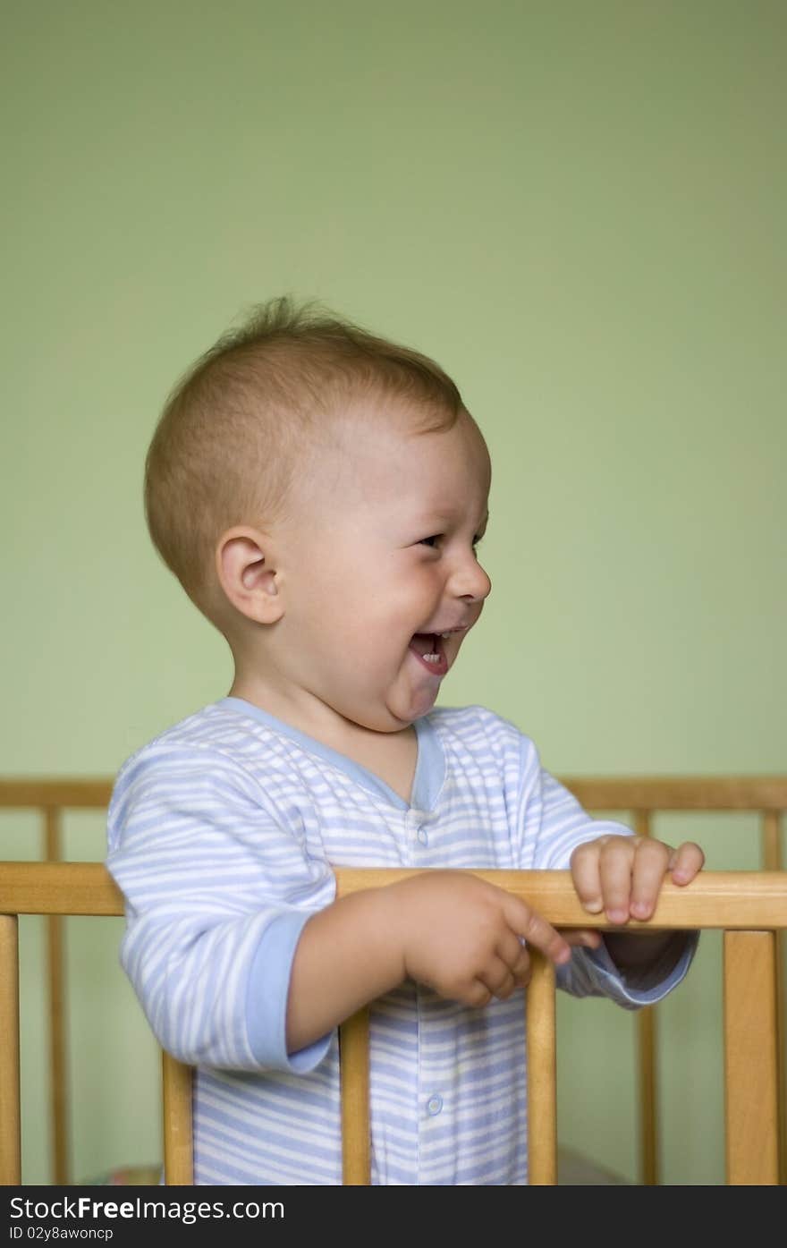 Happy smile baby boy in bed. Happy smile baby boy in bed