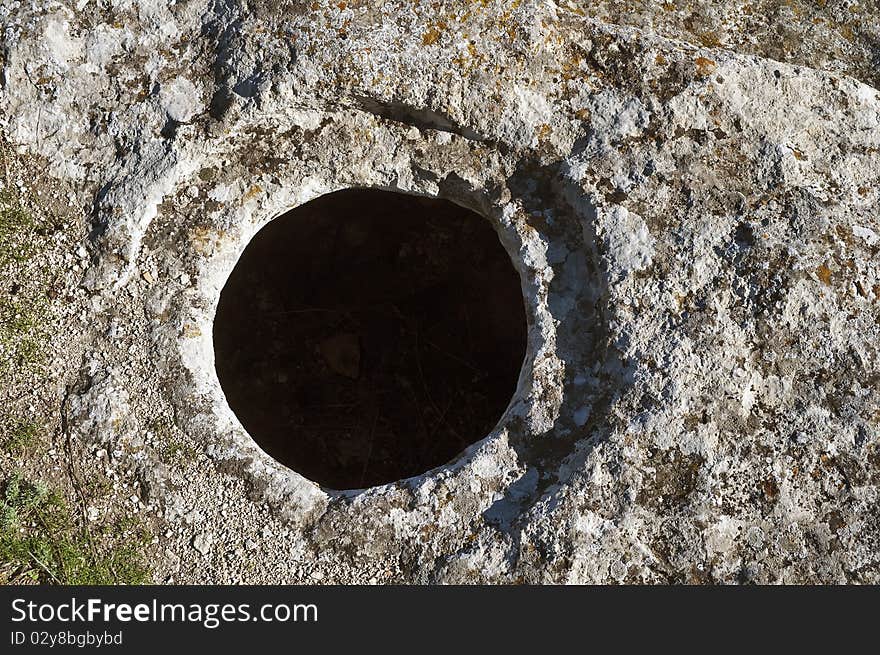 The hole in the rock. Medieval cave city Buckla in Crimea.