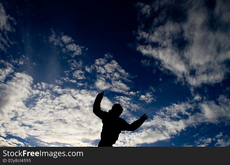 Man jumping in blue sky. Man jumping in blue sky