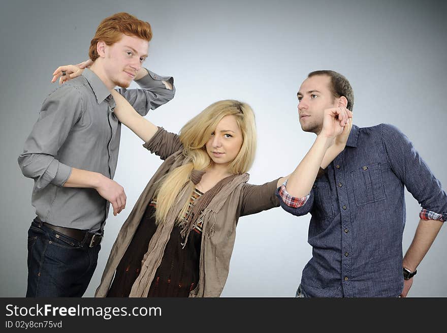 Two white men and one blonde woman dancing together. Two white men and one blonde woman dancing together