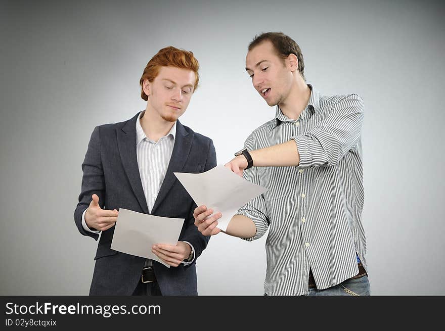 Two white business men discussing in office about contracts. Two white business men discussing in office about contracts