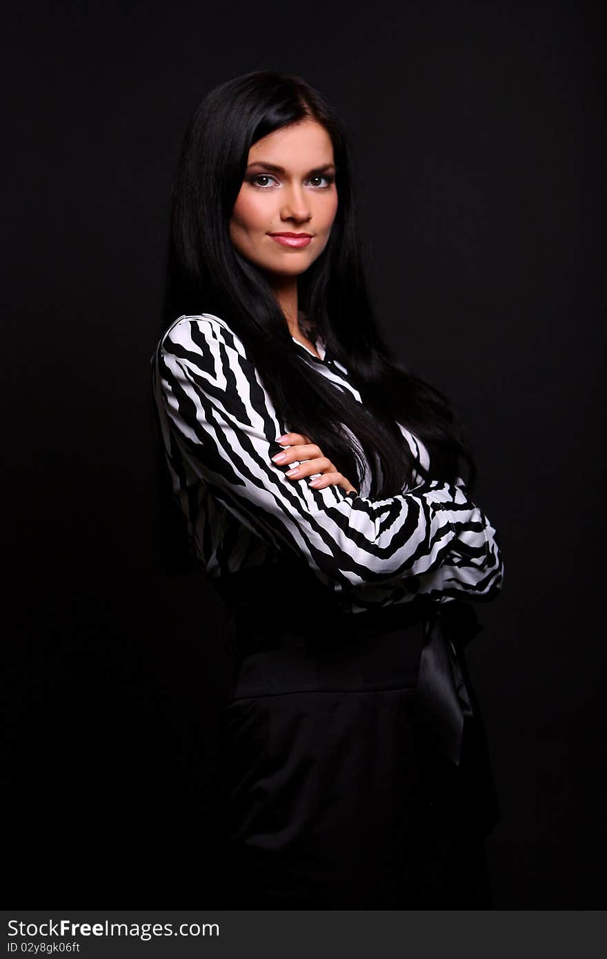 Young and attractive smiling girl in striped blouse at black background. Young and attractive smiling girl in striped blouse at black background