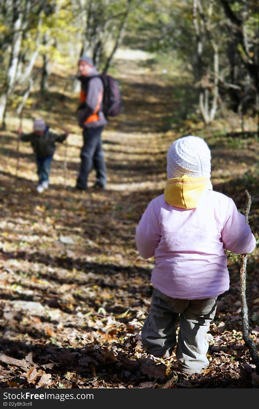 Father and kids in autumn forest