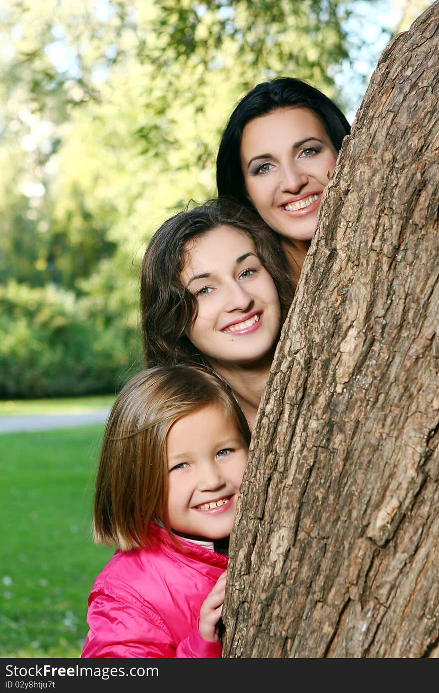 Young family taking healthy stroll through autumn park and have fun. Young family taking healthy stroll through autumn park and have fun