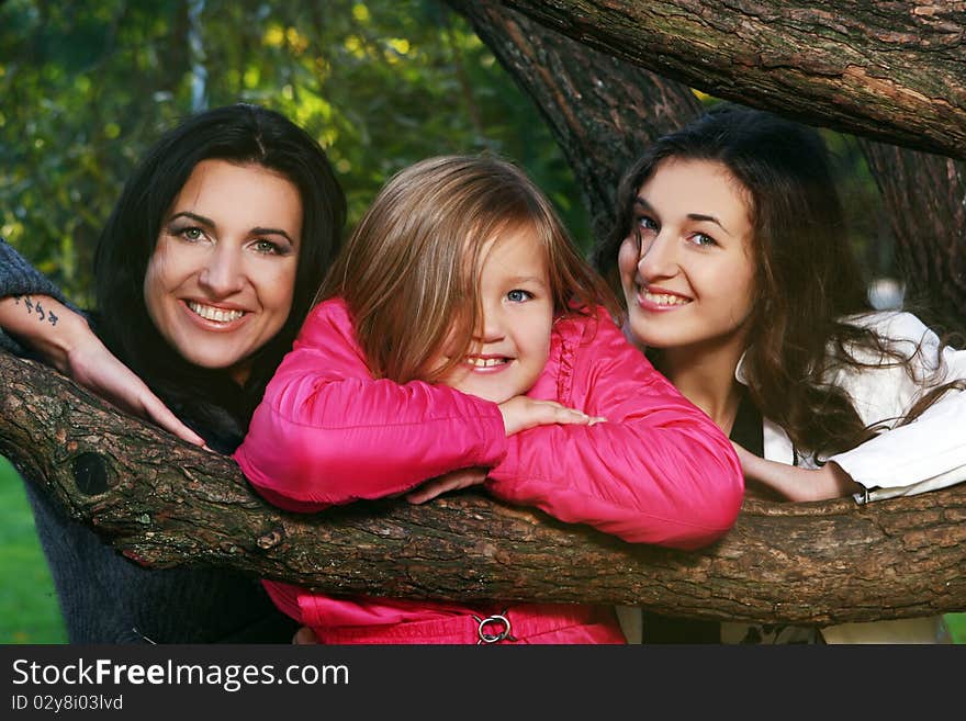 Young family taking healthy stroll through autumn park and have fun. Young family taking healthy stroll through autumn park and have fun