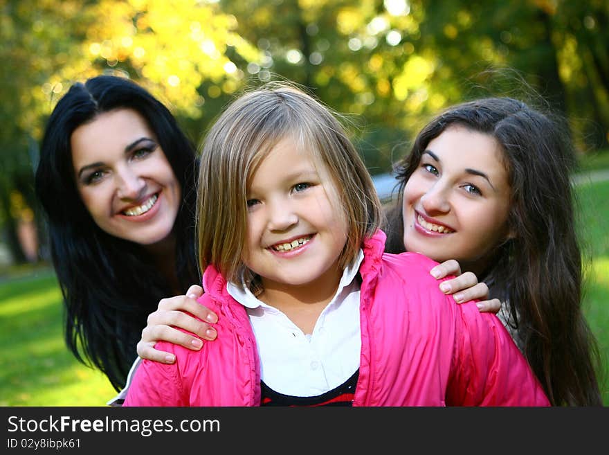 Young family taking healthy stroll through autumn park and have fun. Young family taking healthy stroll through autumn park and have fun