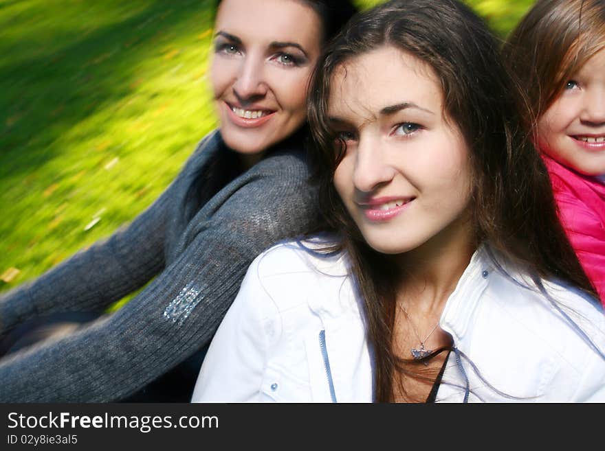 Young family taking healthy stroll through autumn park and have fun. Young family taking healthy stroll through autumn park and have fun