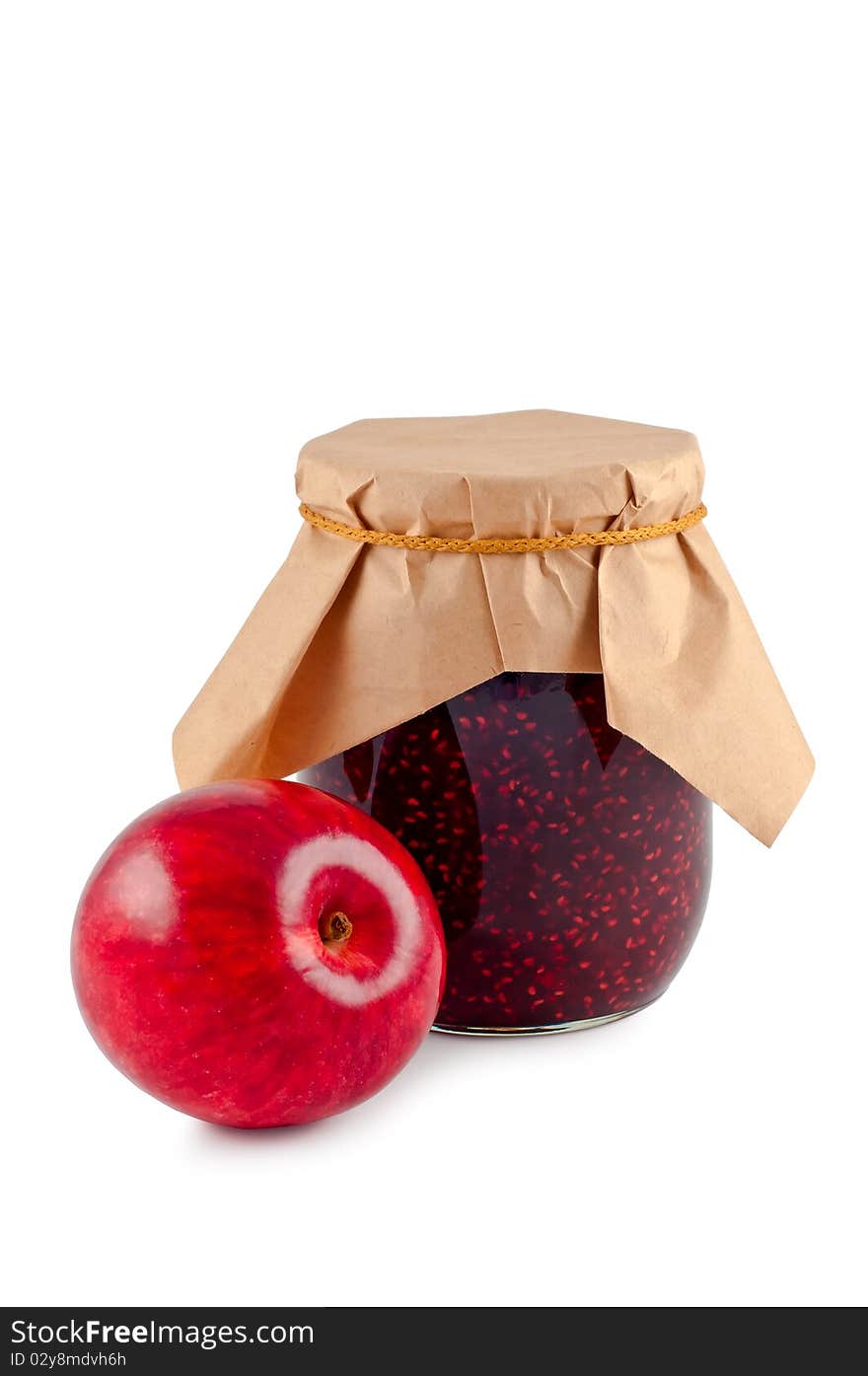 Jam in a glass jar with an apple.