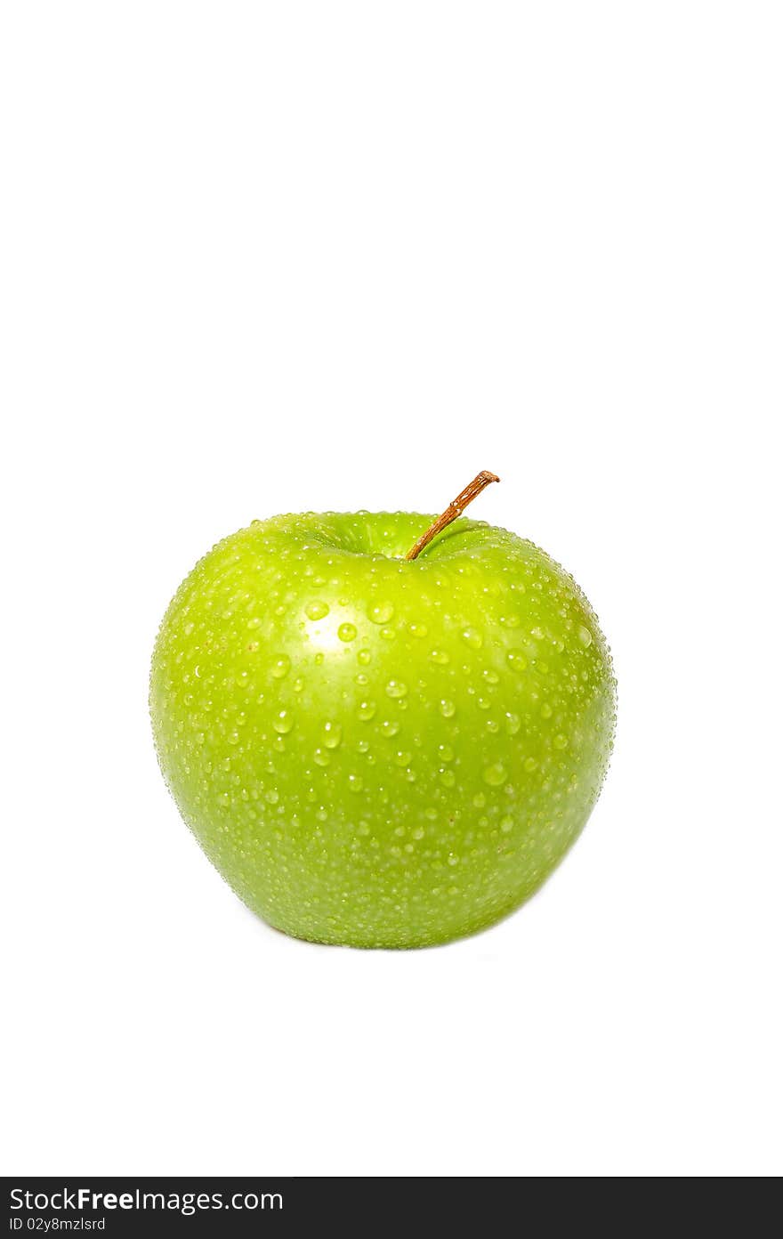 Fresh green apple covered with water drops