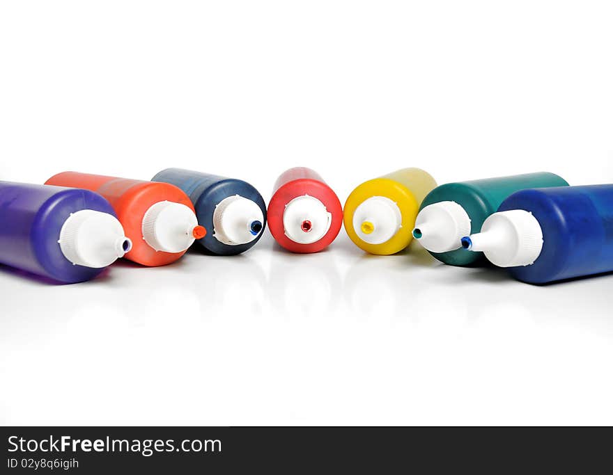 Various color tubes on white background