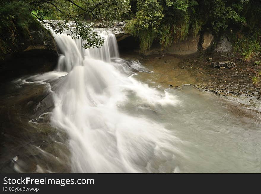 It is a waterfall in the cloudy day