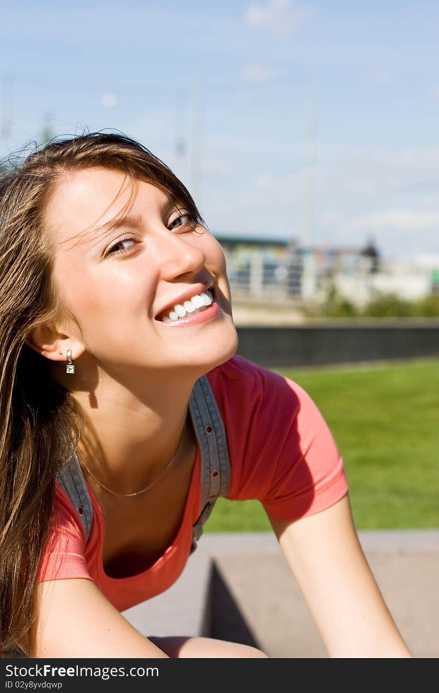 Young happy brunette on a sunny day