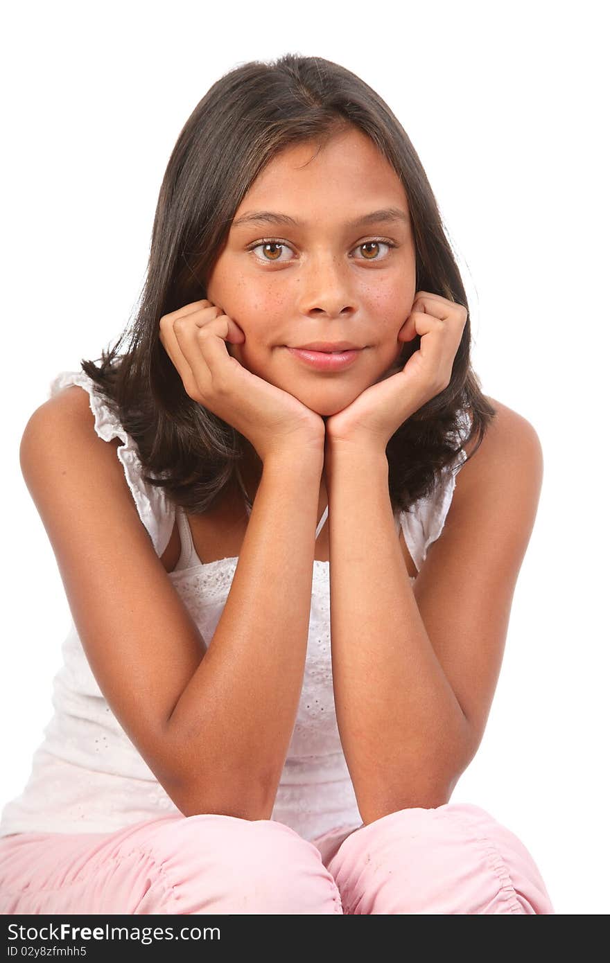 Studio portrait of young teenage girl, 13, sitting with elbows on knees and resting chin in hands - Canon 5D MKII. Studio portrait of young teenage girl, 13, sitting with elbows on knees and resting chin in hands - Canon 5D MKII