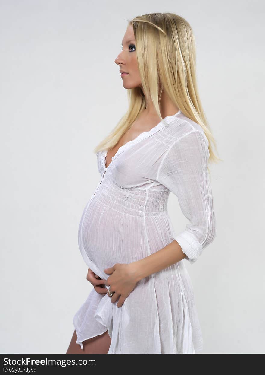 The Pregnant Young Girl On The White