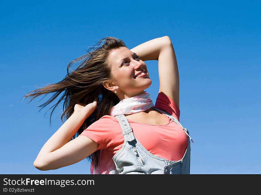 Young happy confident girl looks at the sun. Young happy confident girl looks at the sun