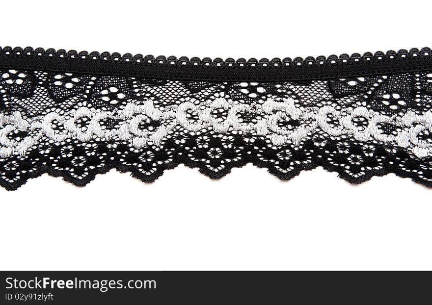 Black lace with pattern in the manner of white flower on white background