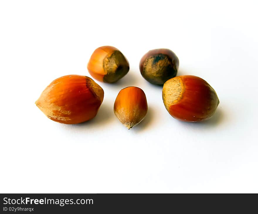 Heap of hazelnuts isolated over white background