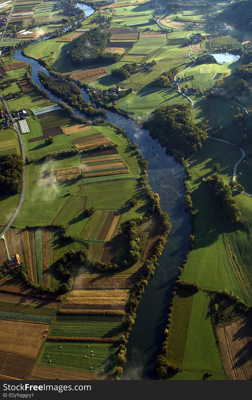 View from above on the countryside with river and fields.