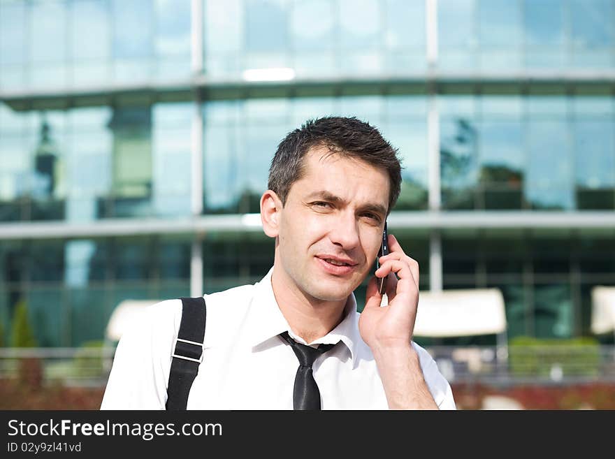 Manager speak on phone across office building