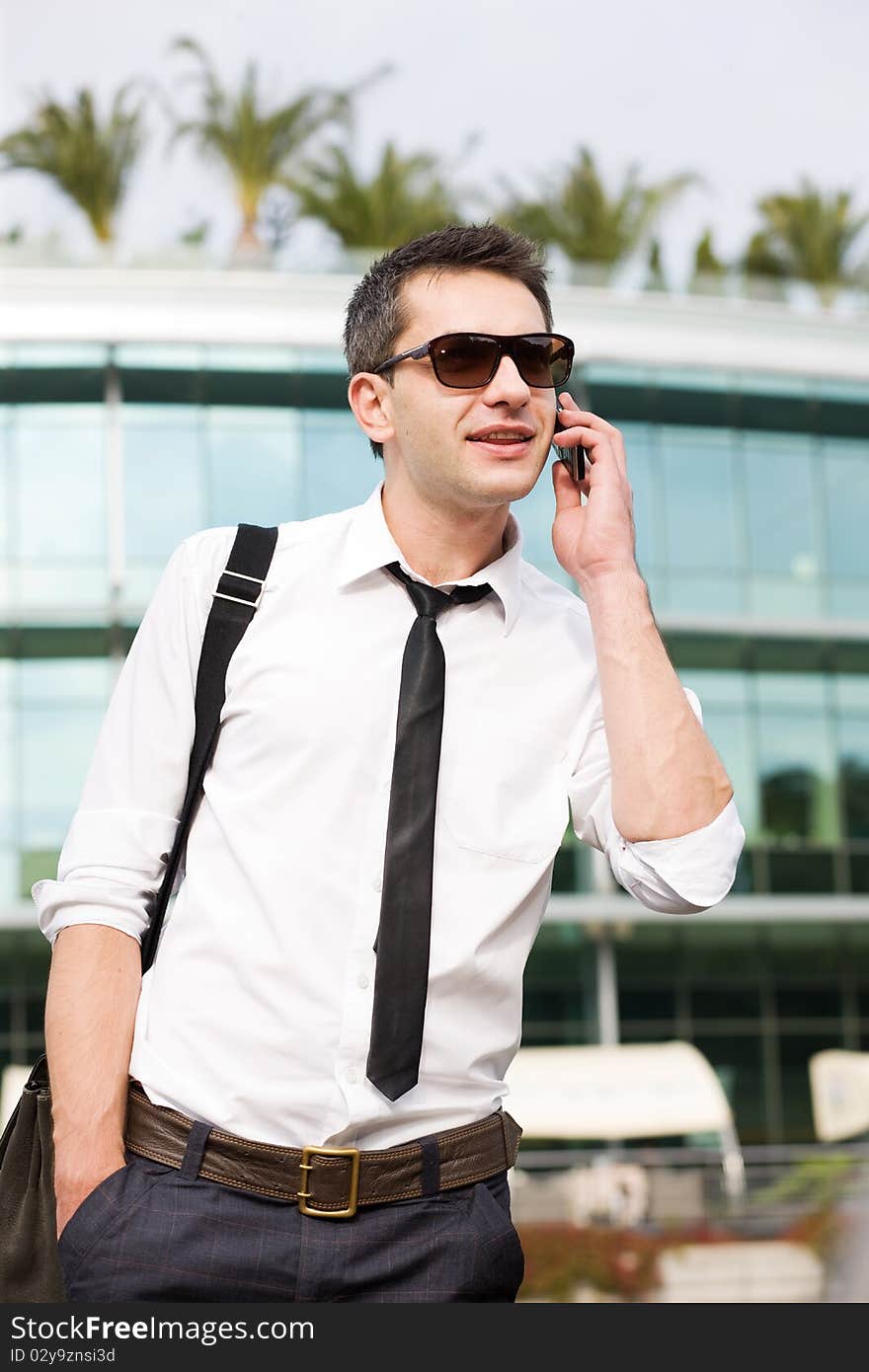 Manager speak on phone across office building