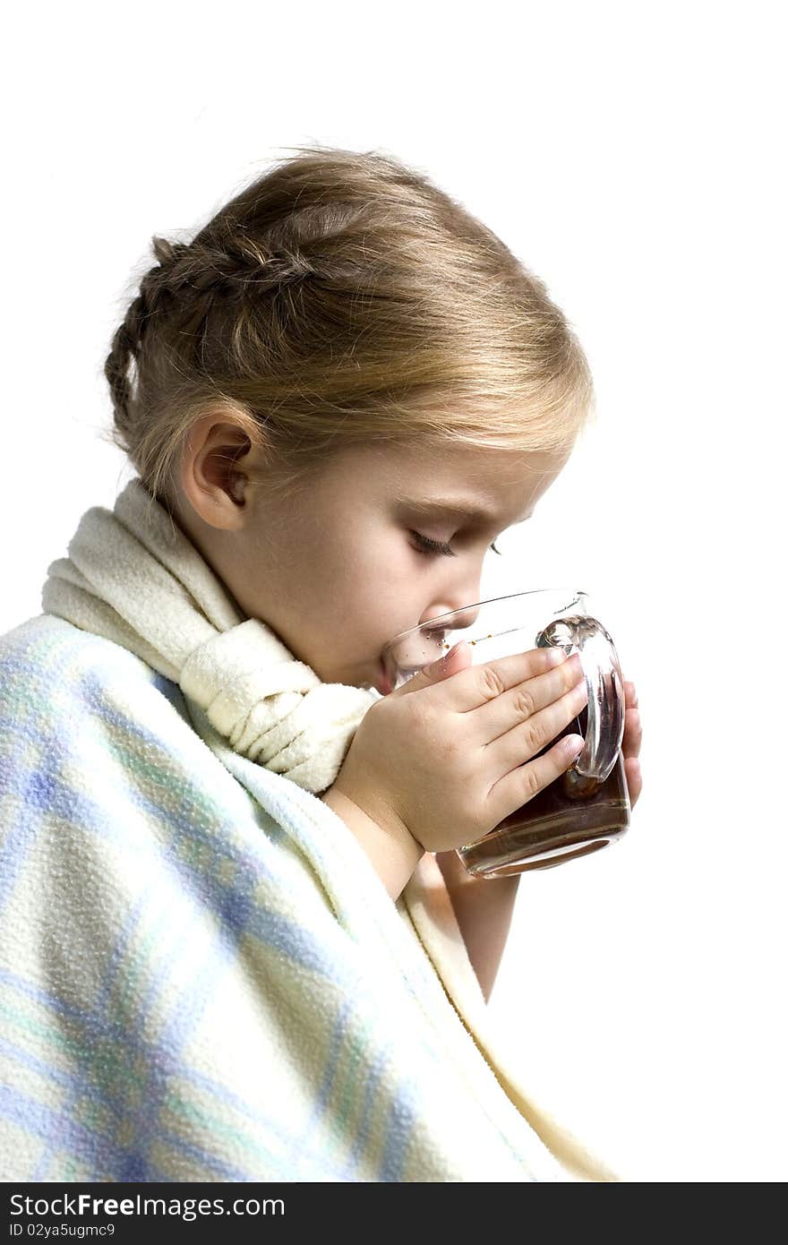 Child in scarf is ill with cup of tea. Child in scarf is ill with cup of tea