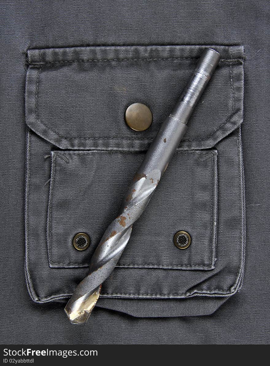 A Masonry Drill on the pocket of a workman's jacket.