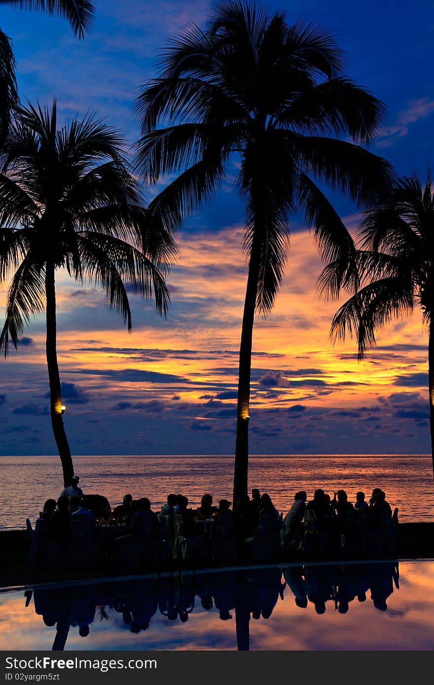 Group of people having diner on the beach at a sunset. Group of people having diner on the beach at a sunset