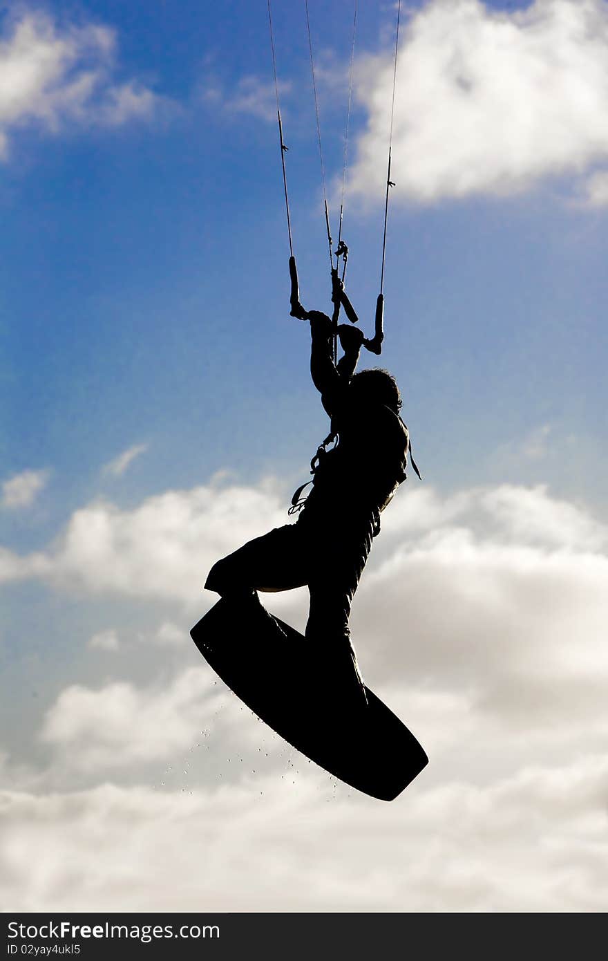 Kite surfer silhouette, jumping and flying high in the air, at the Obidos lagoon, Bom Sucesso, Foz do Arelho, Silver Coast, Portugal