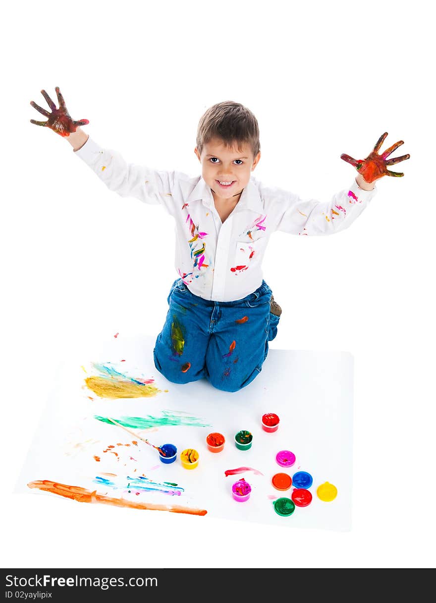 Adorable 3 year old boy covered in bright paint.