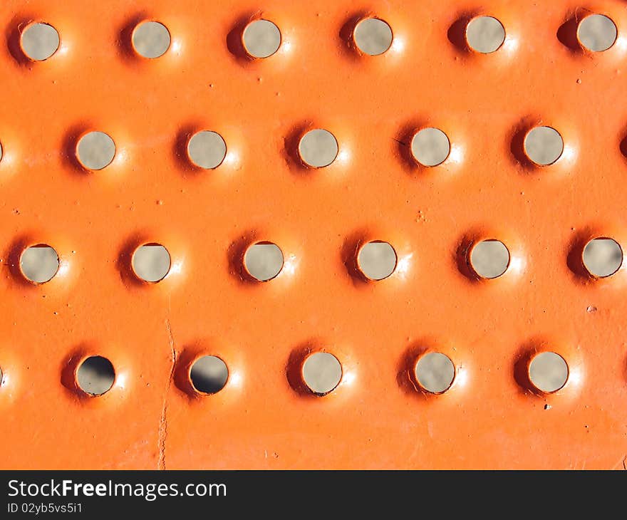 Industrial grunge background of sunburst metal rivets