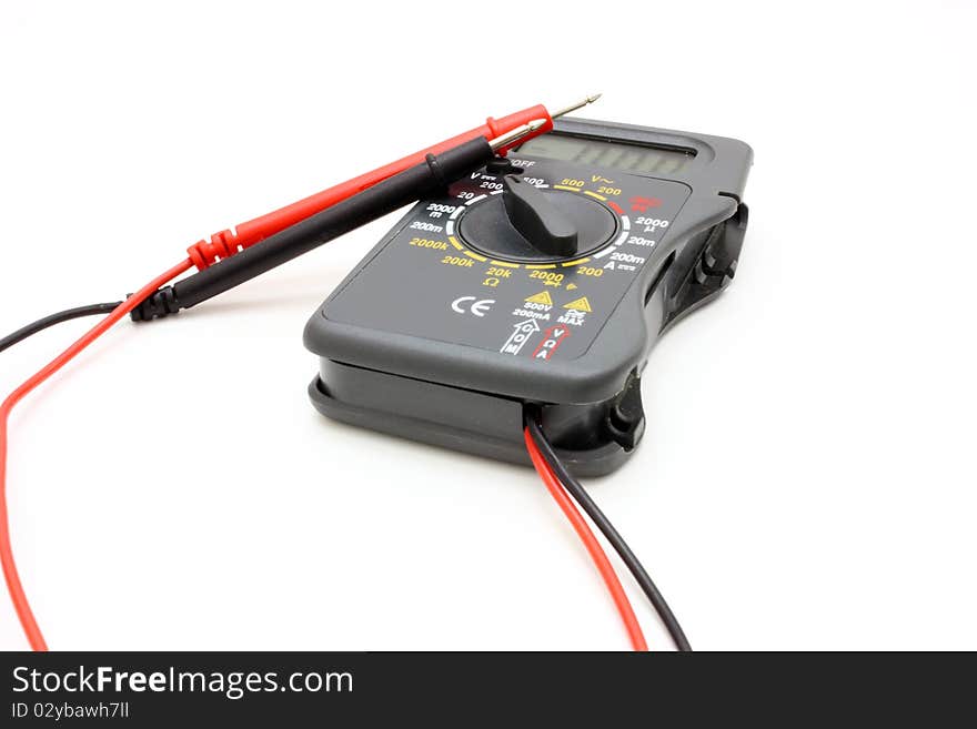 Multimeter of black color with a red and black wire on a white background