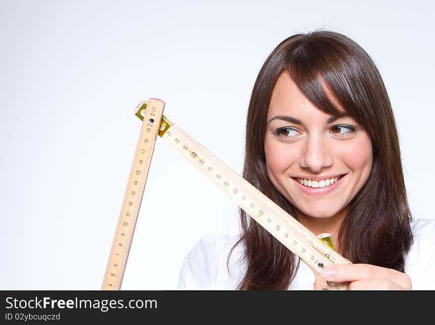 Young woman holding a yardstick. Young woman holding a yardstick