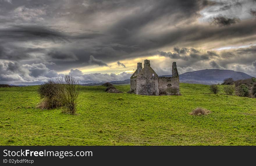 An Irish landscape with an old derelict castle in a very green field and very dramatic skies. An Irish landscape with an old derelict castle in a very green field and very dramatic skies.
