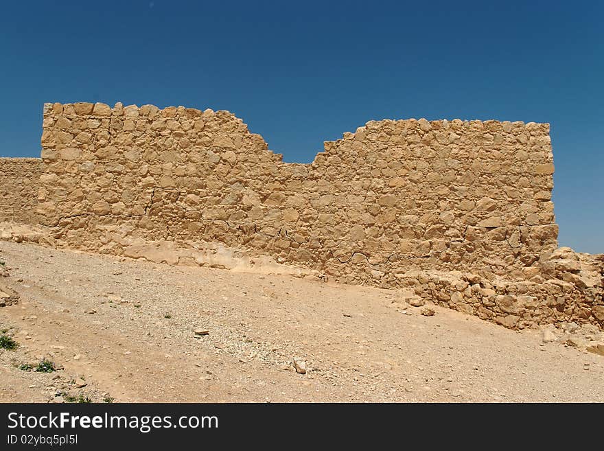 Jagged wall of ancient fortress  in the desert