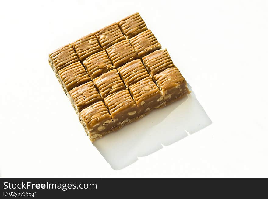 Brown sweet with nuts on a white background