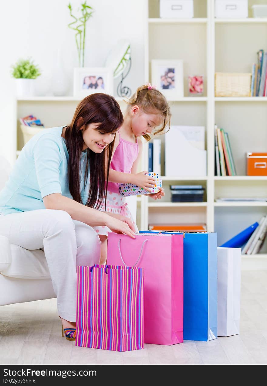 Mother And Daughter With Purchases At Home